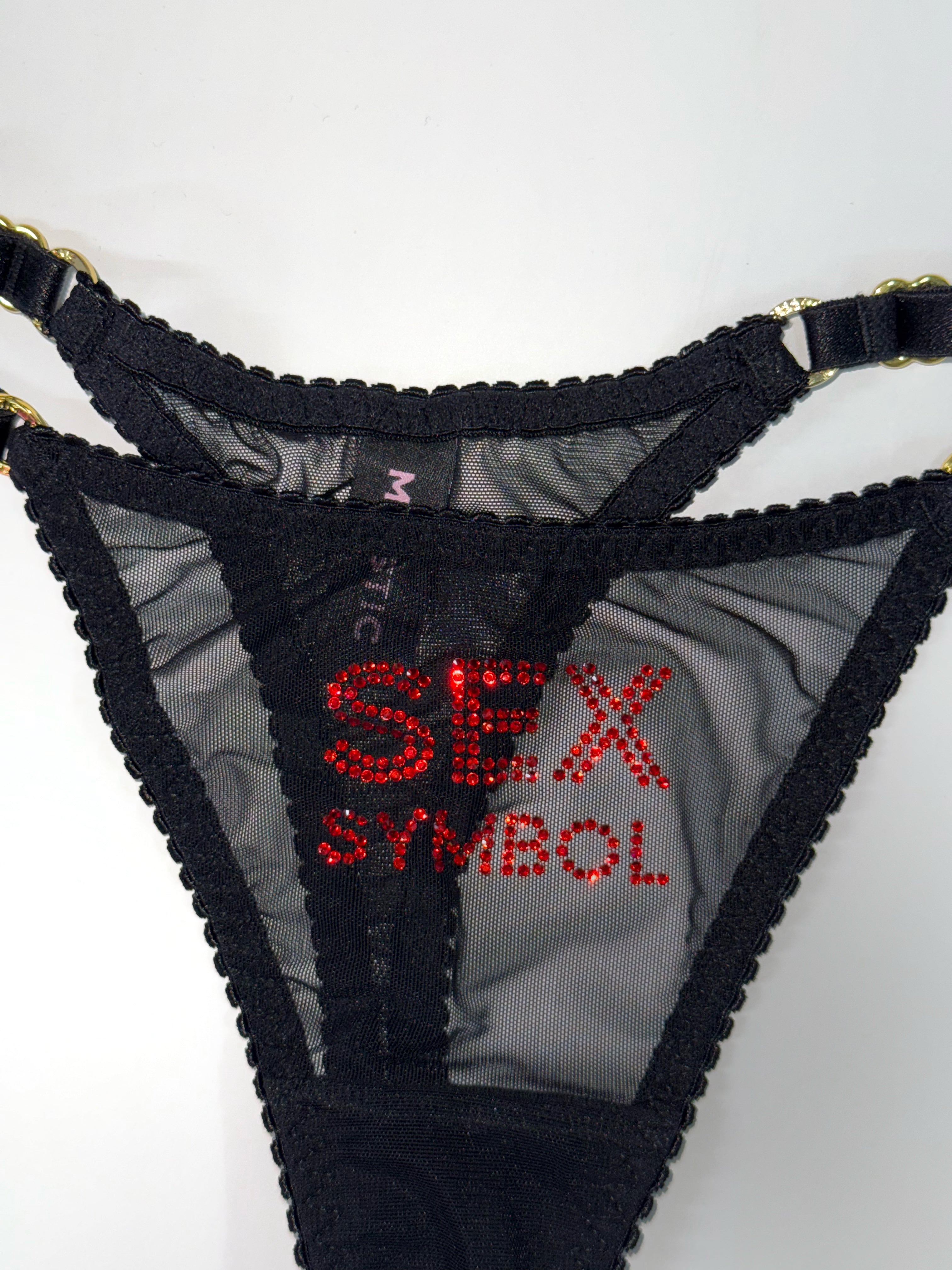 Чорні трусики з сітки з написом Sex Symbol зі страз. 
